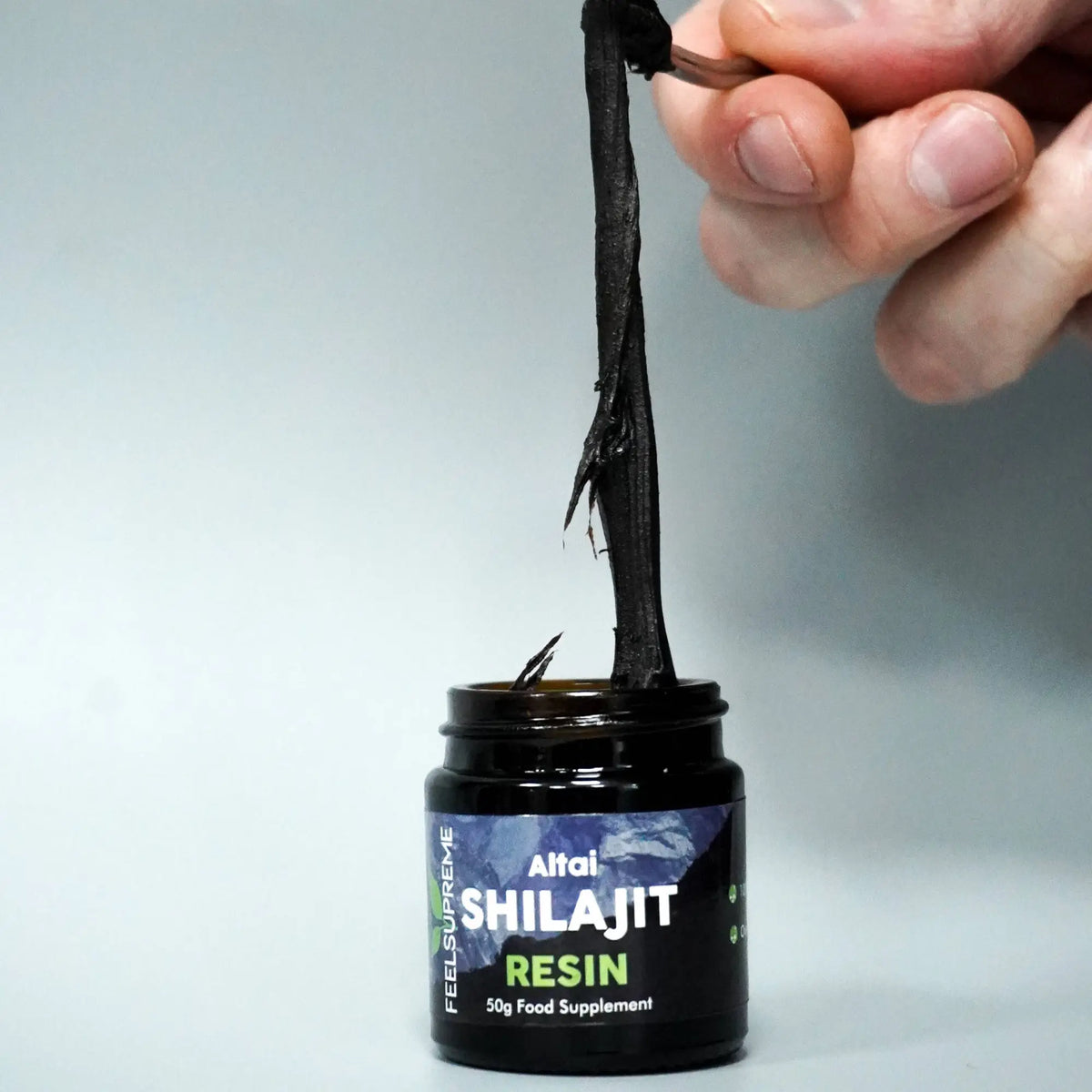 Schwarzes altai shilajit resin in einem dunklen glas mit etikett hochwertiges shilajit als nahrungsergänzung