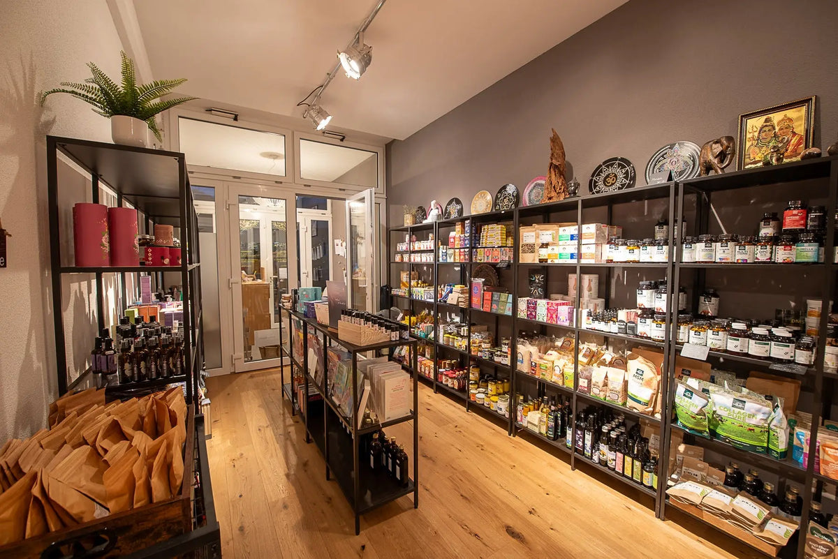 Ein mana shop mit bio produkte und vegane lebensmittel wie ölgläser, supplementboxen und getrocknete ware auf regalen
