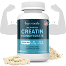Eine Flasche Harmonify Micronized Creatine Monohydrate (2000mg, 60 Portionen, 120g pro Flasche, 60 Kapseln) flankiert von stilisierten, flexenden Armen. Mehrere Kapseln und eine kleine Menge Pulver sind im Vordergrund zu sehen.