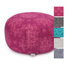 Ein runder Meditationskissen in lebhaftem Magenta mit einem floralen Muster. Das Kissen hat ein kleines Etikett an der Unterseite und wird mit Farbmuster anderer verfügbarer Farben und Muster auf der rechten Seite gezeigt.