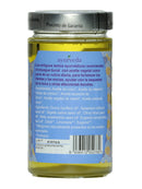 Ein gelbes Ölglas mit einem blauen Etikett, das eine Beschreibung der ayurvedischen Mundspülung sowie die Inhaltsstoffe, Allergene und die Chargennummer E2703 auflistet.