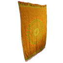 Ein orangefarbenes Tuch mit einem großen, fächerförmigen Pfauenmuster in Grün- und Orangetönen, umgeben von einem filigranen floralen Muster und mit Fransen an den Rändern, auf weißem Hintergrund.