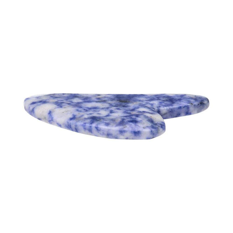 Seitenansicht eines blauen Sodalith Gua Sha Massagesteins, der sein glattes, flaches Profil und gesprenkeltes Blau-Weiß-Muster zeigt.