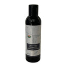 Eine schwarze Flasche Ayurveda Specialist Kesaranjini Thailam ayurvedisches Kräuteröl mit botanischem Etikett.