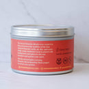 Die Rückseite der Cacao Laboratory FIRE Ceremonial Grade Cacao Dose auf einer weißen Marmoroberfläche. Das korallenrote Etikett beschreibt die Sacred Elements Blends, spezifiziert die „FIRE“-Mischung mit Kurkuma und schwarzem Pfeffer zur Aktivierung der Leidenschaft und listet die Geschmacksnoten als „Earth, aromatic spice“ auf.