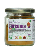 Ein kleines Glasgefäß mit ayurveda Auténtico Cúrcuma Polvo BIO (Bio-Kurkumapulver), einem gelben, aromatischen Gewürz. Das Etikett hebt hervor, dass es traditionell im Ayurveda wegen seines Curcumin-Gehalts verwendet wird, 100g enthält, 100% natürlich, GVO-frei, glutenfrei und ein Bio-Produkt (Biorgánico) ist.