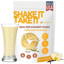 Eine Packung SHAKE IT TAKE IT WellnessPro Mahlzeitenersatz-Shake für Frauen, Vanillegeschmack, 480g, mit 15g pflanzlichem Protein, 2g Zucker, 6g Ballaststoffen, gekennzeichnet als Keto-freundlich, GMO-frei und Glutenfrei. Ein Glas Shake steht daneben.