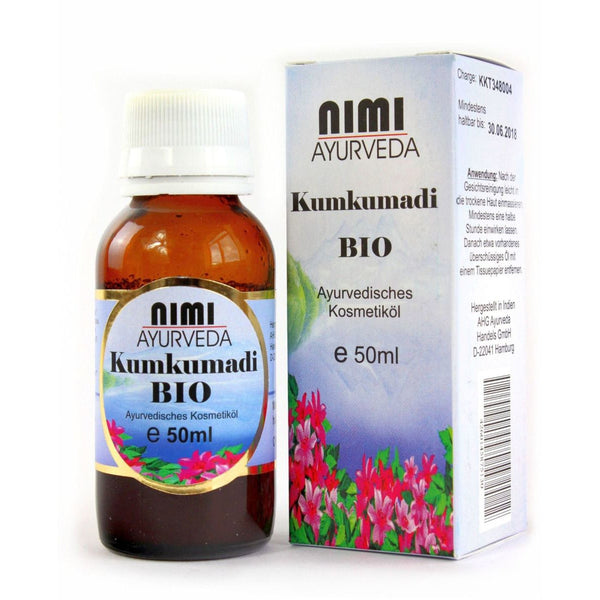 Eine 50ml Braunglasflasche NIMI AYURVEDA Kumkumadi BIO Ayurvedisches Kosmetiköl neben der Verkaufsverpackung.