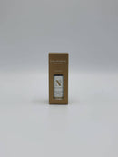 Kleine braune Pappschachtel mit einer Flasche Süßes Orangenöl (Laranja Doce).