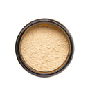 A top-down view of an open jar of Paavani Ashwagandha, revealing the yellowish powder inside, set against a white background.