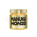 Ein goldener glasbehälter mit anuk manuka-honig mgo250 und schwarzem weißem etikett für hochwertigen premium-honig
