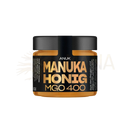 Anuk manuka honey mgo400+ in einer 150g bernsteinfarbenen glasdose mit schwarzem deckel und goldener beschriftung von the mana shop