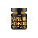 Ein elegantes schwarzes glas mit goldener schrift anuk manuka honig mgo400+ in premiumqualität von the mana shop