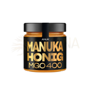 Schwarzer glas mit goldener beschriftung anuk manuka honey mgo400+ mit bernsteinfarbener manuka honig the mana shop