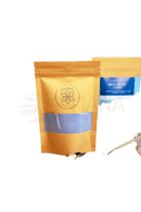 Eine orange wiederverschließbare tasche mit feinem violettem pulver von ayamani naturals blauer samt latte botanischer blue butterfly