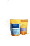 Eine lebendige orange-blaue tasche ayamani naturals blauer samt latte mit wiederverschließbarem oberteil und botanischer blue butterfly zutatenliste