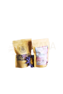 Zwei goldgelbe wiederverschließbare pouches mit ayamani naturals krone chakra kräutertee ginseng 25g etikett