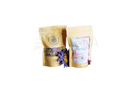 Two beige resealable pouches of ayamani naturals krone chakra kräutertee with cranberry label and ginseng 25g