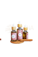 Three ayamani naturals freya oil dropper bottles with bamboo caps and pink labels containing golden liquid for conscious rituals