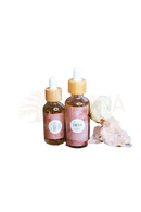 Two amber glass dropper bottles with bamboo caps and pink labels from ayamani naturals freya oil for conscious rituals