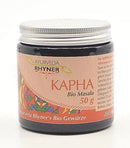 Ein rosa etikettierter glas mit silbernem deckel enthält ayurveda rhyner kapha bio masala 50g bio gewürz aktivierend und scharf von mana shop