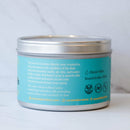 Die Rückseite der Cacao Laboratory WATER Ceremonial Grade Cacao Dose auf einer weißen Marmoroberfläche. Das hellblaue Etikett beschreibt die Sacred Elements Blends, spezifiziert die „WATER“-Mischung mit Koriander und Maca zur Entfaltung der Kreativität und listet die Geschmacksnoten als „Roasted nuts, citrus“ auf.