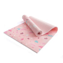 Eine schräge Ansicht einer hellrosa Yogamatte mit buntem Terrazzo-Muster, die teilweise ausgerollt ist und das geprägte „myga“-Logo auf weißem Hintergrund zeigt.