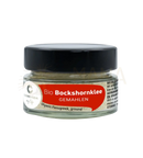 Ein durchsichtiges glas mit schwarzem deckel enthält bio bockshornklee gemahlen von cosmoveda für verdauung und immunstärkung bei mana shop