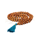 Coiled mala yoga necklace of warm brown sandalwood beads with vibrant blue tassel and sandalwood scent by bodynova