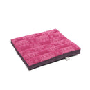 Ein rechteckiges, rosa Meditationskissen mit einem sich wiederholenden hellrosa Lotusmuster auf der Oberseite und dunkelviolettem Stoff an den Seiten.