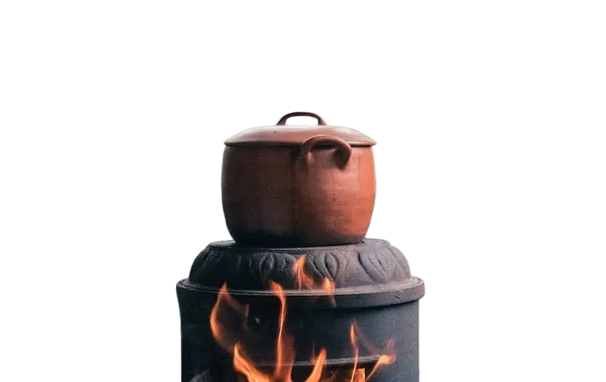 Ein rustikaler terrakotta-topf mit deckel und griffen auf einem schwarzen ofen zeigt cascara sagrada traditionelles pflanzenrindenprodukt aus nordamerika