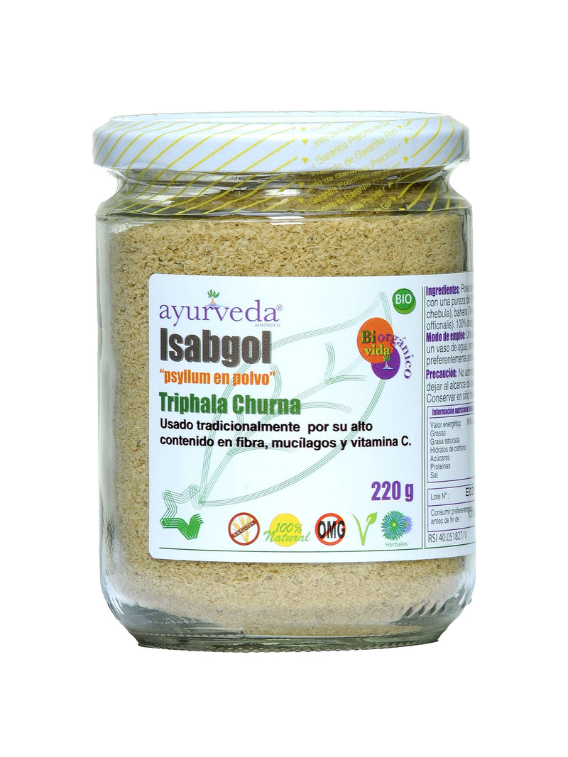  Ein Glasgefäß mit gelb-weiß gestreiftem Deckel enthält "Ayurveda autentico Isabgol" (Flohsamen in Pulverform) "Triphala Churna". Das Etikett zeigt "220 g", "BIO", "100% Natur", "Sin Gluten" und "OMG" (gentechnikfrei) Symbole.