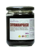 Chyawanprash Ayurveda Auténtico, klassisches Kräuterelixier, in einem Glasbehälter, mit Zutaten und Kräutern sichtbar.