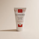Nährende Bio-Handcreme mit Baobaböl von COMPTOIR DES HUILES, zeigt die pflegende Textur und die Verpackung der Körperpflege.