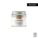 Ein Glas "Comptoir des Huiles Le Gommage" Peeling mit der Aufschrift "Bestseller" oben links und dem ECO CERT COSMOS NATURAL Logo unten rechts.