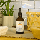 Grünes Expert Bio-Gesichtsmassageöl von COMPTOIR DES HUILES für trockene Haut, Flasche mit Massageöl in der Hand.