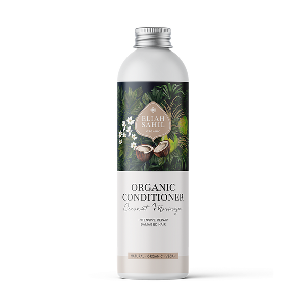 Produktfoto einer weißen Flasche „Eliah Sahil Organic Conditioner Coconut Moringa“ mit einem dunklen Etikett im Naturthema, das Kokosnüsse und grüne Blätter zeigt und intensive Reparatur für geschädigtes Haar verspricht.