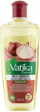 Eine Nahaufnahme einer transparenten Plastikflasche Vatika Naturals Red Onion Multivitamin Hair Oil zur Kontrolle von Haarausfall. Das Etikett zeigt die Illustration einer aufgeschnittenen roten Zwiebel und gibt an, dass das Öl 100% natürlich ist, 7Vitamine enthält und 200ml umfasst.
