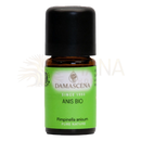 Eine kleine bernsteinfarbene glasflasche mit schwarzem verschluss und grünem damascena anis bio etikett naturreines anisöl für aromatherapie