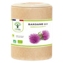 Ein zylindrischer Kraftpapier-Behälter mit „Bardane Bio“ (Bio-Klette) von Bioptimal. Das weiße Etikett zeigt zwei lila Klettenblüten, die französische Flagge und Bio-Zertifizierungssymbole.