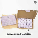 Offener Karton mit einzeln verpackten Tiefenreinigungstabletten für die Waschmaschine. Auf der Schachtel steht „12 Tabs, 1 Jahresvorrat“. Der niederländische Text lautet „jaarvoorraad tabletten“.