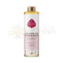 A clear glass bottle with gold cap contains eliah sahil bio körper- und haaröl sandelholz golden-yellow organic oil