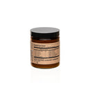 Rückseite eines Ergänzungsmittels im Glas, auf dem die Nährwertangaben für eine Kurkuma-Mischung mit Zutaten wie Kurkuma, Ingwer und Ashwagandha zu sehen sind.