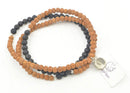 Kurzes Mala aus Rudraksha und Lavastein von GangaPrem, handgefertigter Schmuck mit natürlichen Steinen.