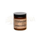 Ein glas mit schwarzem deckel und beigem etikett enthält das bernsteinfarbene goldene milch gewürz von paavani ayurveda im mana shop