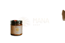 Ein glas mit paavani ayurveda goldene milch mit schwarzem deckel und beigefarbenem etikett mit goldener schrift im mana shop