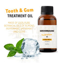 Braune glasflasche mit schwarzem rippverschluss und weißem etikett groomarang extra strength zahn- und wundpflege öl für das zahnfleisch 15 ml