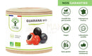 Ein zylindrischer behälter guarana bio kapseln für energie mit holzfarbener abdeckung und schwarzen guarana beeren von mana shop