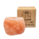 Ein rustikaler himalaya salz kerzenhalter mit natürlicher form und warmem rosa-orangefarbenem kristalliner struktur