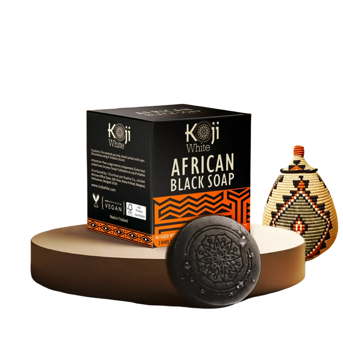 Schwarze afrikanische Seife von Koji White in zylindrischer Form, reich an natürlichen Inhaltsstoffen, ideal für Hautpflege.